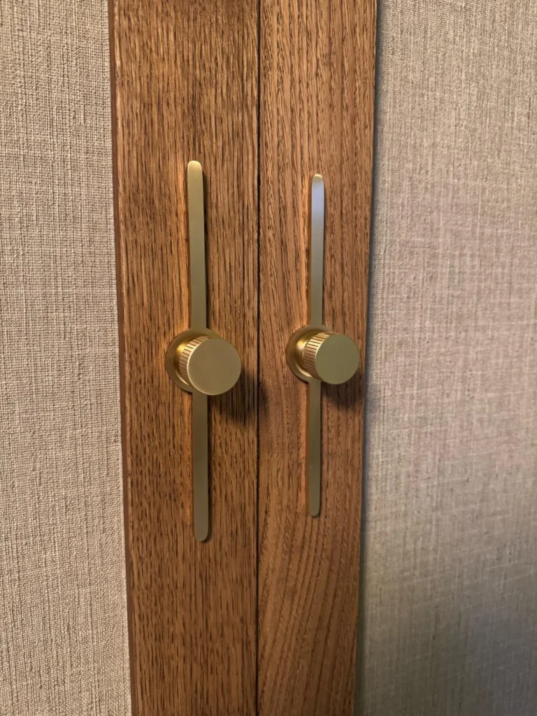 Walnut joinery with brass handles finished by Gilbert Construction